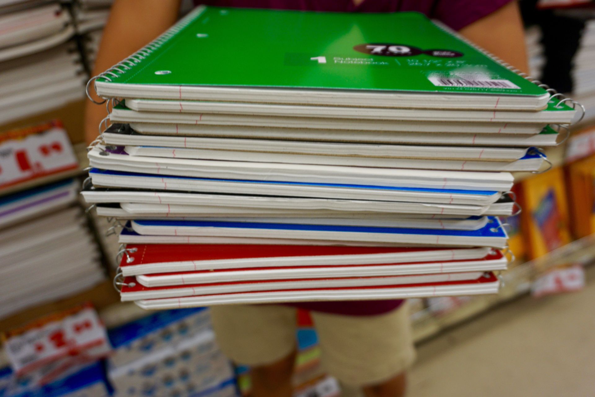 holding-pile-of-notebooks-for-back-to-school-shopp-2024-10-17-02-43-45-utc